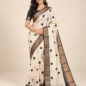 Model wearing an ivory Tussar silk polka dot saree with antique copper gold zari border and black blouse